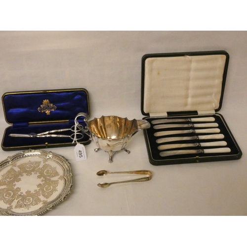 495 - A silver plated card waiter, sauce boat, two cases of mother of pearl handled tea knives, chamber st... 