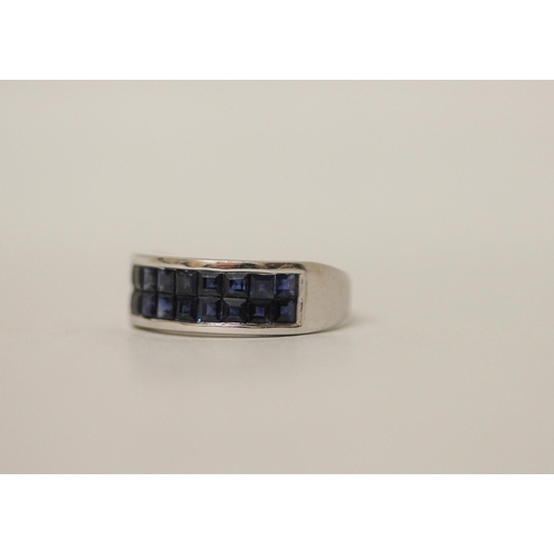 546 - A modern 9ct white gold and blue sapphire band, set with a double row of calibre cut sapphires on ha... 