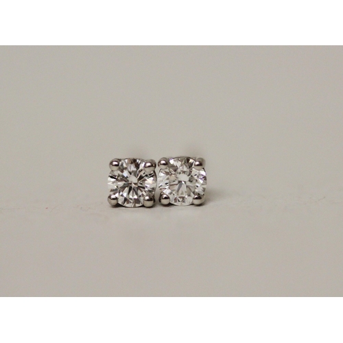 547 - A pair of diamond ear studs, the diamonds claw set to 18ct white gold posts, marked 750