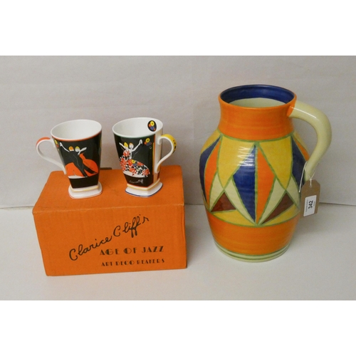 342 - A large Bizarre jug after Clarice Cliff in the Bizarre style together with a pair of modern beakers ... 