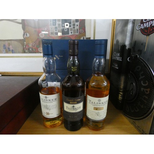 19 - A collection of two bottles of Clan Campbell Scotch whiskey, a bottle of Johnny Walker green label, ... 