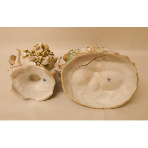88 - Two Continental porcelain cherub and floral decorated lamp bases, tallest one measuring 31cm