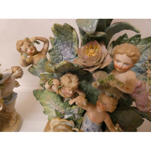 88 - Two Continental porcelain cherub and floral decorated lamp bases, tallest one measuring 31cm