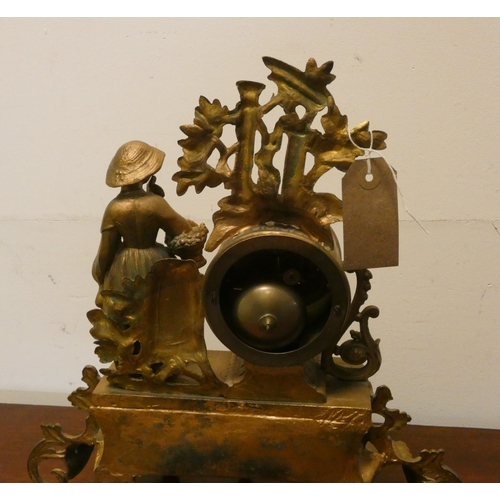 11 - A French striking gilt figure mounted mantel clock with a porcelain panel