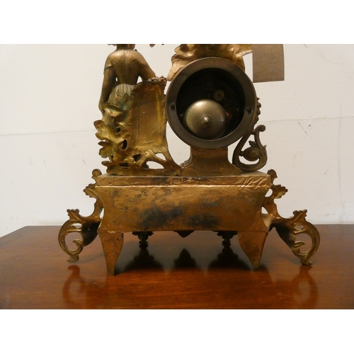 11 - A French striking gilt figure mounted mantel clock with a porcelain panel