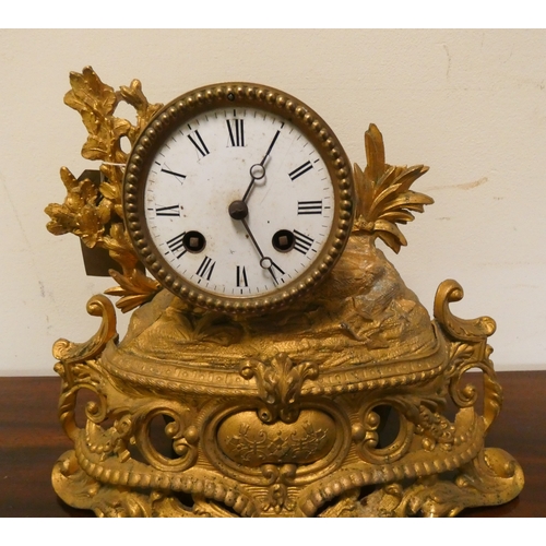 4 - A French striking mantel clock in decorative gilt metal case