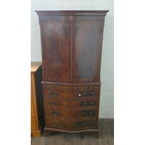 64 - A Georgian style mahogany serpentine front tallboy fitted cupboards and one long drawer, 27