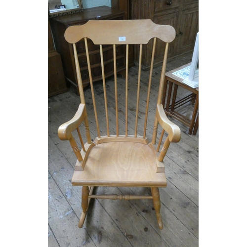 66 - A modern spindle backed rocking elbow chair