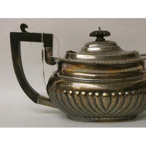 400 - A late Victorian silver teapot, of half lobed form, with ebony handle. Chester 1899, 18 oz troy all ... 