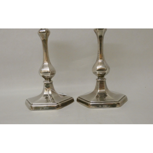 401 - A pair of silver candlesticks of baluster form, on hexagonal weighted bases. Detachable sconces, hal... 