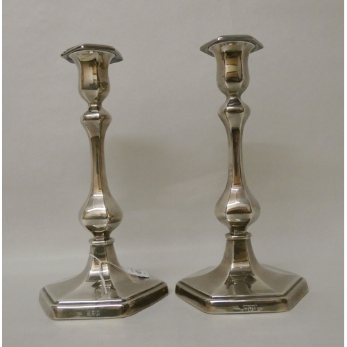 401 - A pair of silver candlesticks of baluster form, on hexagonal weighted bases. Detachable sconces, hal... 