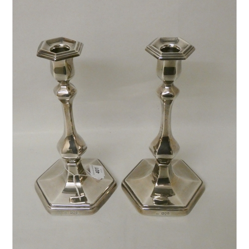 401 - A pair of silver candlesticks of baluster form, on hexagonal weighted bases. Detachable sconces, hal... 