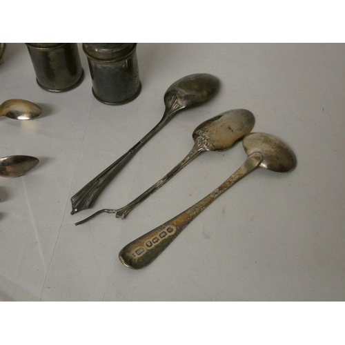 403 - A silver cream jug, two pairs of silver sugar nips, salt & pepper pots and three silver spoons. Weig... 