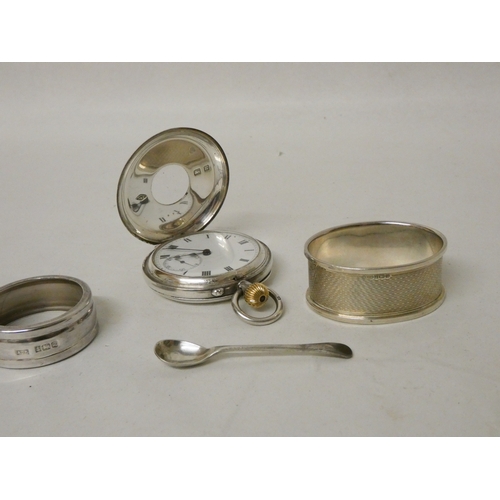 409 - A silver cased pocket watch, a salt spoon and two silver napkin rings.