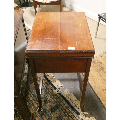 113 - An Edwardian mahogany fold over top desk with well interior, 20