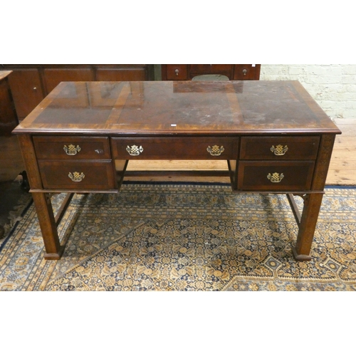 115 - A Georgian style mahogany writing desk with cross banded top fitted with five drawers with brass han... 