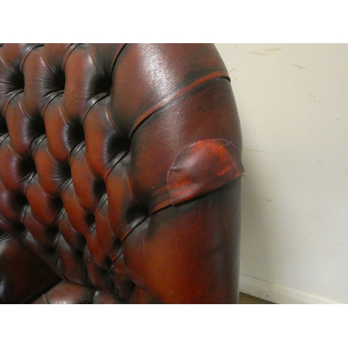 117 - A red buttoned leather revolving office elbow chair