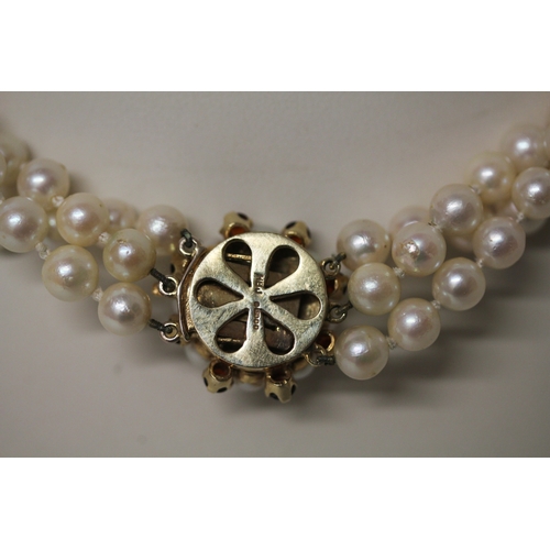 423 - A Triple Row Cultured Pearl Choker, with A Cultured Pearl and garnet Cluster Clasp, hallmarked 9ct g... 