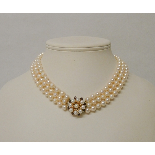 423 - A Triple Row Cultured Pearl Choker, with A Cultured Pearl and garnet Cluster Clasp, hallmarked 9ct g... 