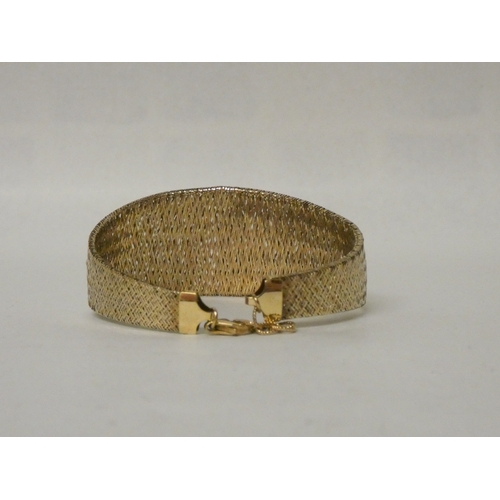 428 - A wide modern 9ct gold mesh cuff style bracelet. 6g