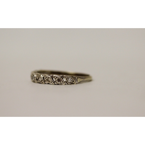 446 - A 9ct white gold diamond band, hallmarked, ring size Q. Gross weight 2.4g