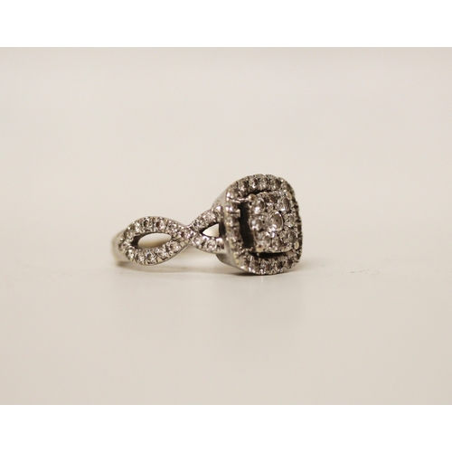 444 - A modern diamond cluster ring in a square setting to cross over diamond shoulders, hallmarked, ring ... 