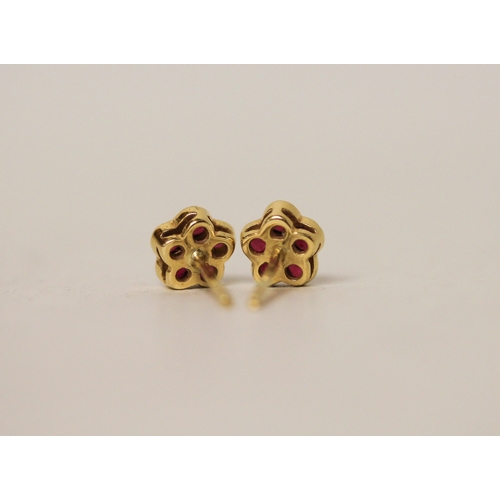 457 - A pair of modern 18ct gold ruby and diamond flower head cluster stud earrings, gross weight 2.4 gram... 