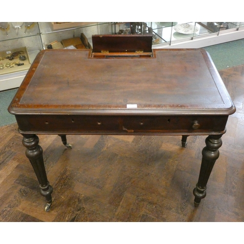 A Victorian mahogany writing table with a hinged pen compartment to the ...