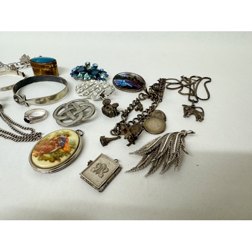 413 - Two silver charm bracelets, two silver bangles, silver and marcasite deco ring, vintage butterfly wi... 