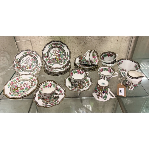 221 - A collection of Coalport Indian Tree design cups and saucers together with a milk jug.