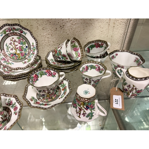 221 - A collection of Coalport Indian Tree design cups and saucers together with a milk jug.