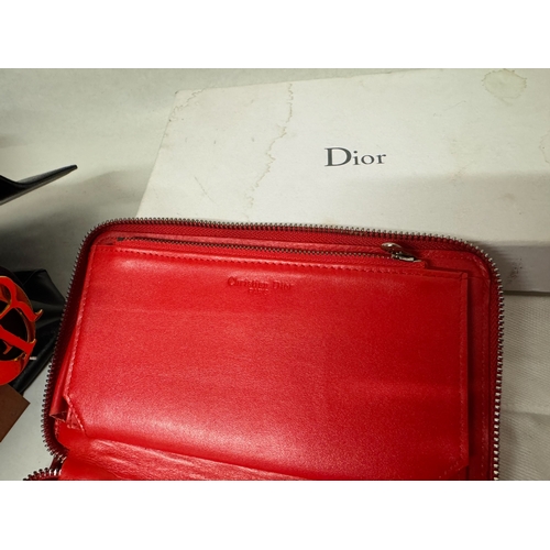 541 - A black leather handbag with Dior labels and a red quilted gloss clutch bag in Dior box