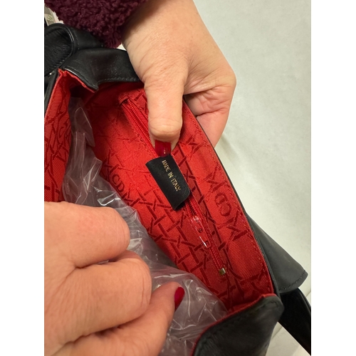 541 - A black leather handbag with Dior labels and a red quilted gloss clutch bag in Dior box