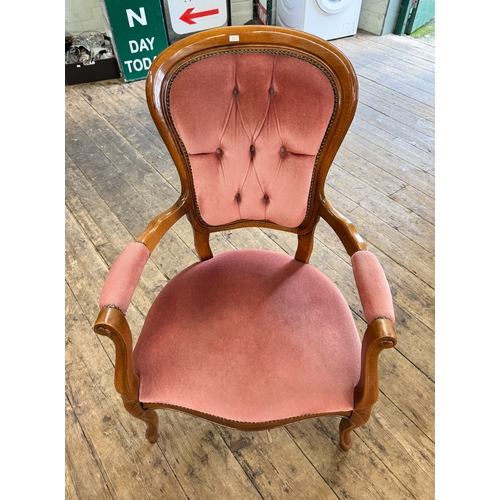 40 - A Victorian style mahogany framed elbow chair upholstered in pink draylon
