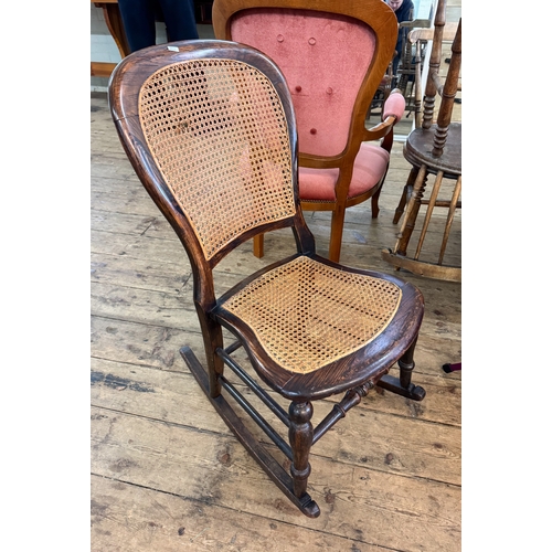45 - An Edwardian simulated rosewood rocking chair with cane panelled seat and back
