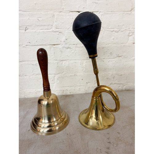 637 - A large brass school style bell together with a large brass taxi horn