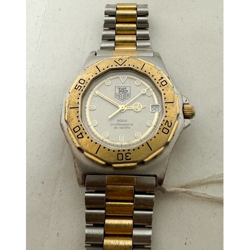 563 - A gent's Tag Heuer 3000 Professional quartz date wrist watch on a gilt and stainless steel strap