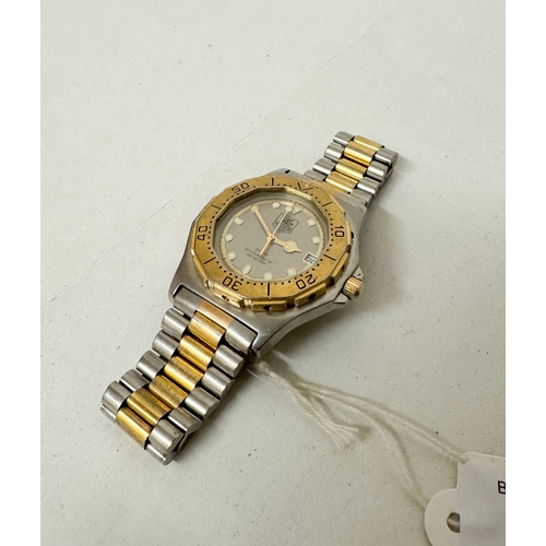 563 - A gent's Tag Heuer 3000 Professional quartz date wrist watch on a gilt and stainless steel strap