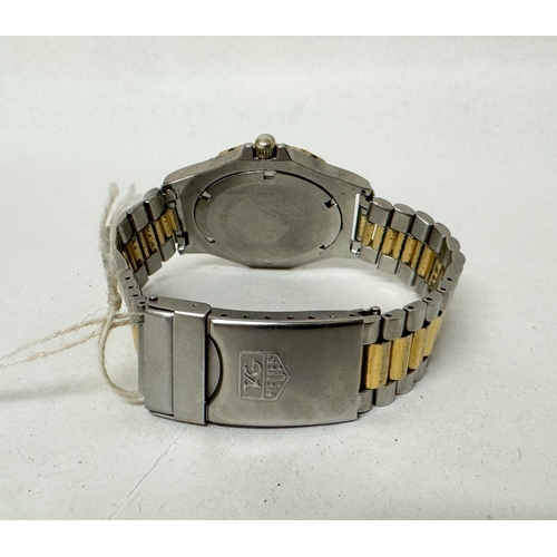 563 - A gent's Tag Heuer 3000 Professional quartz date wrist watch on a gilt and stainless steel strap