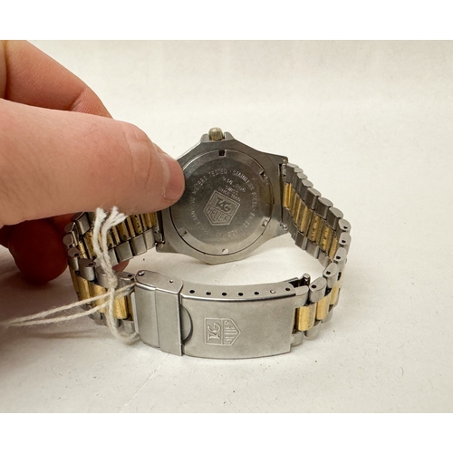 563 - A gent's Tag Heuer 3000 Professional quartz date wrist watch on a gilt and stainless steel strap