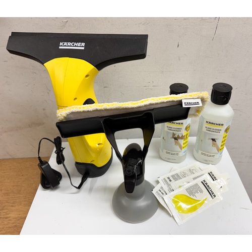 612 - A Karcher window cleaner spray bottle and a window vacuum with glass cleaner bottled liquid