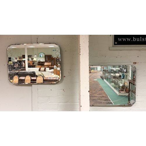 141 - Two frameless bevelled edged wall mirrors