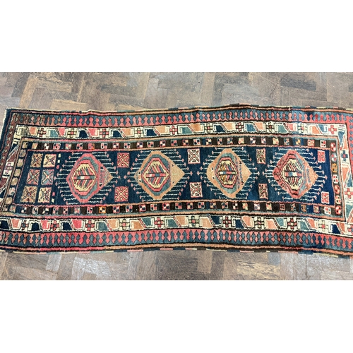 154 - A blue and patterned wool pile Persian runner, 7'6