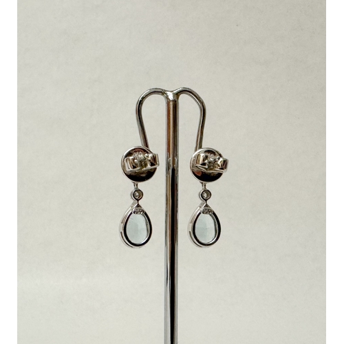 462 - A pair of quality aquamarine and diamond modern drop earrings. The tear drop aquamarines suspended f... 