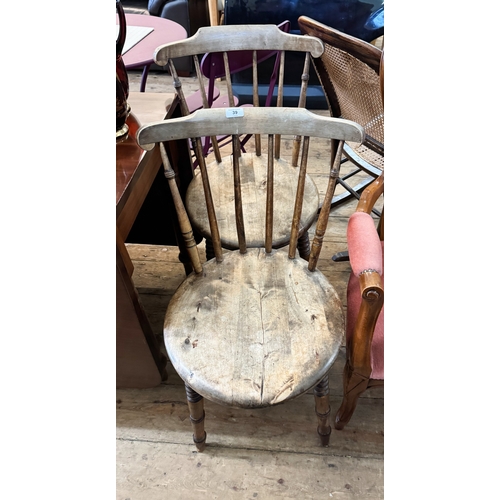 39 - A pair of Windsor round seat stick backed dining room chairs