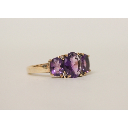 440 - A three stone amethyst and diamond dress ring on hallmarked 9ct gold band. Ring size P, 3.8g