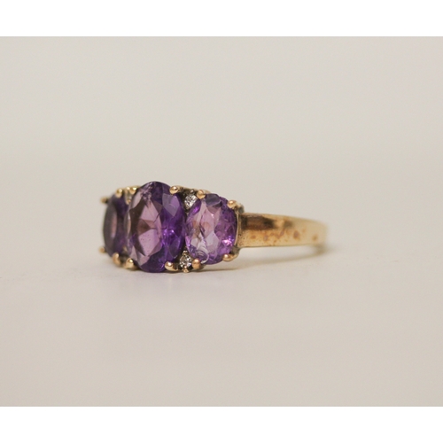 440 - A three stone amethyst and diamond dress ring on hallmarked 9ct gold band. Ring size P, 3.8g