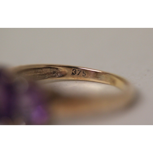 440 - A three stone amethyst and diamond dress ring on hallmarked 9ct gold band. Ring size P, 3.8g