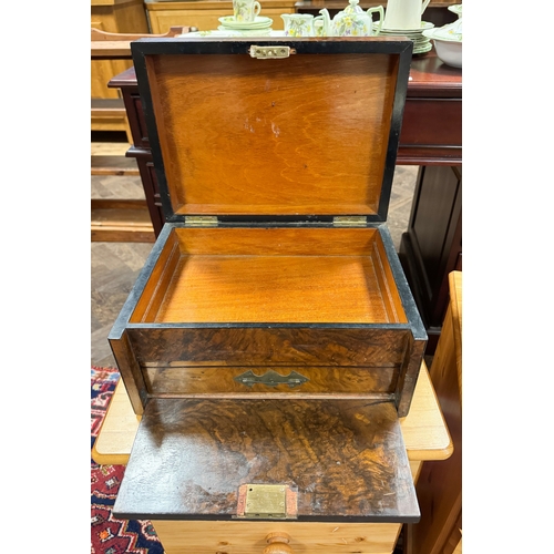 310 - A Victorian walnut travelling case with drop flap and concealed drawer opening to reveal a writing s... 