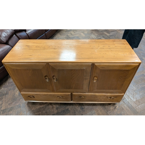 4 - An Ercol blond elm sideboard fitted three cupboards with two drawers under, 4'3